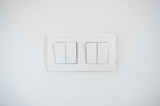 White light switches on the white wall