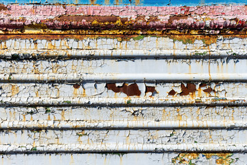 old cracked rusty damaged painted metal background texture close-up