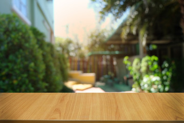 Empty dark wooden table in front of abstract blurred bokeh background of restaurant . can be used for display or montage your products.Mock up for space.