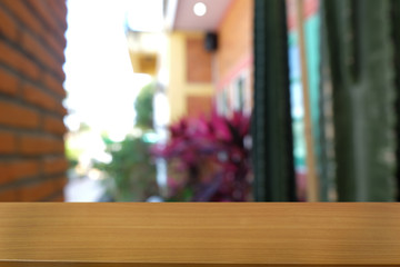 Empty dark wooden table in front of abstract blurred bokeh background of restaurant . can be used for display or montage your products.Mock up for space.