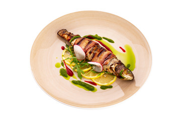 Plate of grilled mackerel fish served with sauce isolated at white background.