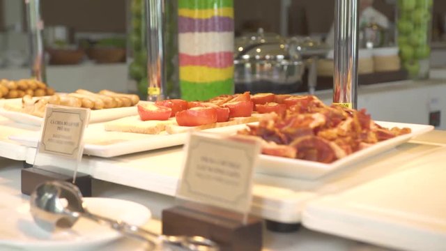 Breakfast buffet table in luxury resort hotel restaurant with assorted bakery food, pastries, sweet cereal. Food for traditional morning breakfast and brunch in all inclusive resort hotel.