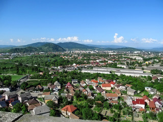 Fototapeta premium Mountain panorama of Mukachevo - view from the balcony of Palanok Castle. Beautiful spring and summer landscape of a small town in Transcarpathia (Ukraine)