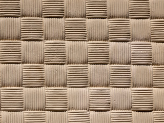 A Quilted pattern, found on a cemented wall, suitable for use as textured background. 