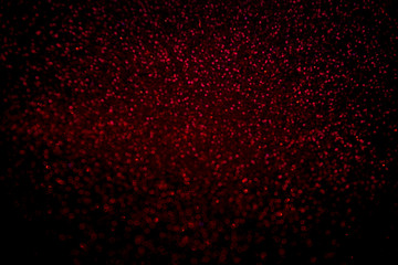 Fototapeta na wymiar Abstract red glitter confetti sparkles on black background. Holiday background. Christmas concept. 