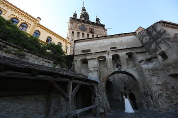 Fototapeta premium Beautiful wedding couple posing near old castle