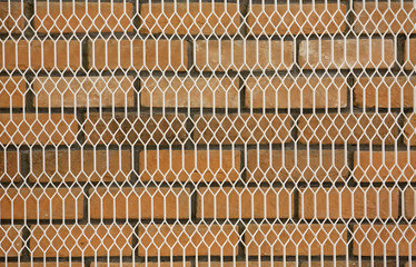 Grille and stone brick wall background.