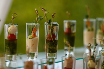 Cocktails with mozzarella, cherry tomatoes and herbs