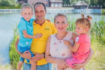 Harmony and luck in the family concept with parents and kids at countryside. Happy family walking outdoors. Concept of friendly family 