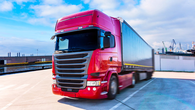 Truck in port . The red truck in a warehouse . Truck logistics building . the red truck in port, delivery of freight.