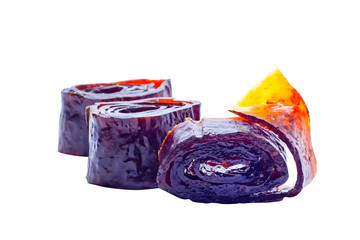 Homemade organic vegetarian natural pastille. Slices of fruit paste in rolls. Delicious helthy candys made from berries and fruit. Isolated on white background with clipping path.