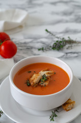Bowl of  tomato soup on the marble table