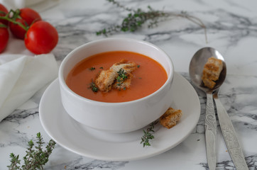 Bowl of  tomato soup on the marble table