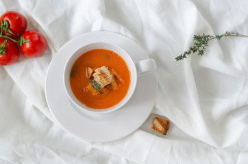 Bowl of  tomato soup on white background.