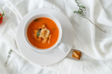 Bowl of  tomato soup on white background.