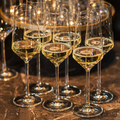 Glasses of champagne on table against blurred background