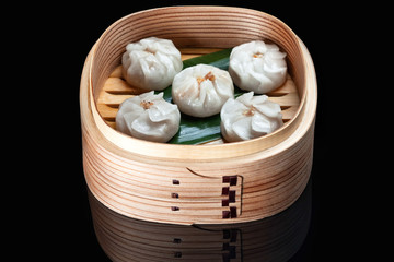 Hinkale in wooden utensils on a black background