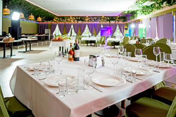 Served tables in restaurants and cafes, meals and drinks on the tables, room design.
