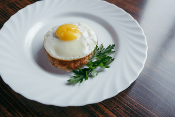 Fried Eggs on a plate wooden background