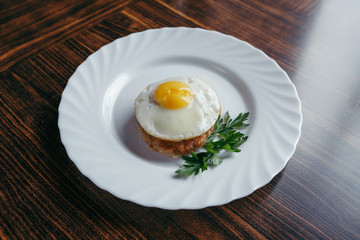 Fried Eggs on a plate wooden background