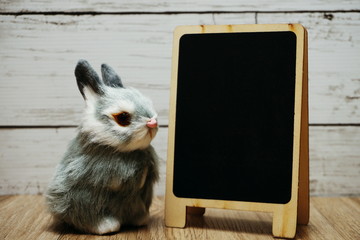 happy easter with bunny rabbit and space copy wooden easel background