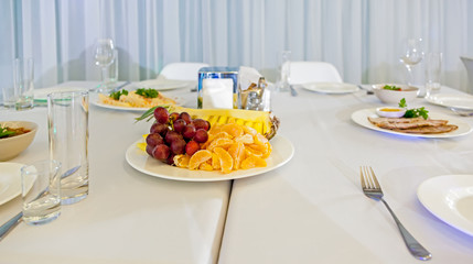 Served tables in restaurants and cafes, meals and drinks on the tables, room design.