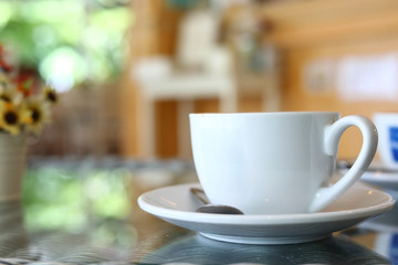 white cup of hot coffee drink put on table in cafe restaurant