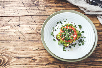 Avocado toast. Healthy toast with avocado mash and tomatoes on a plate.