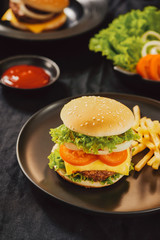 Homemade burger and cheese with fries and icy soft drink