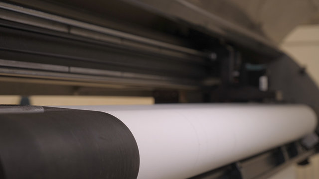 The printing machine prints the code on the paper (fabric) date, time code, and lines for cutting in the future. Concept of: Automatic typewriter, Very close, Factory, Shop, Quick work, Samples.