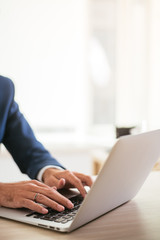 Typing on a laptop. Hands on a keyboard. Typing at the office.