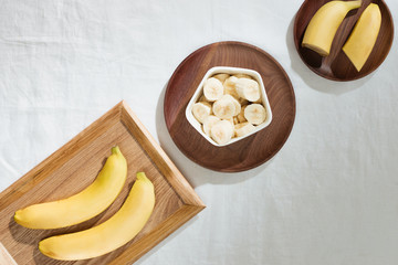 Bananas and banana pieces in a wooden plate