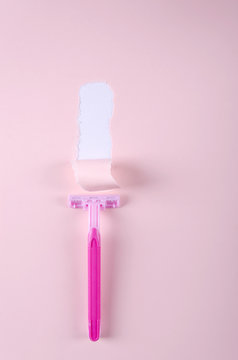 Torn Paper And Sharp Pink Razor On The Pink Backround.Vertical Shot.Concept Of Safe Shaving