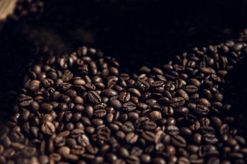 Roasted coffee beans. Dark background with copy space