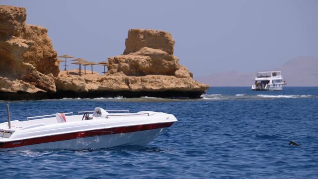 Motor Boat at Anchor in the Sea against the Landscape of Rocky Beach and the Coastline in Egypt