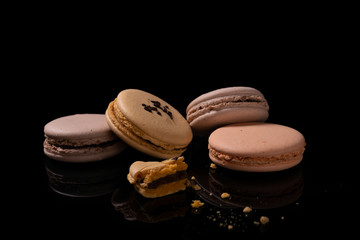 Sweet macarons or macaroons on a black background.