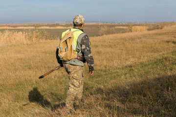 Hunter with a german drathaar and spaniel, pigeon hunting with dogs in reflective vests	