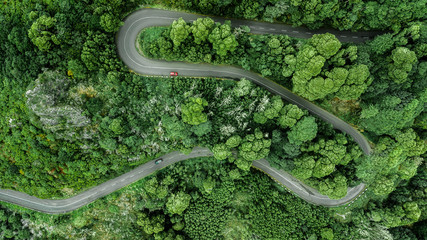 Aerial view of winding road trough the dense woods on the high mountain in Encumeada, Ribeira...