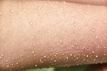 Goosebumps and drops of water on the female skin. 
