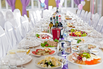Served tables in restaurants and cafes, meals and drinks on the tables, room design.