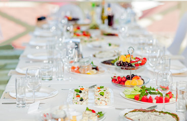 Served tables in restaurants and cafes, meals and drinks on the tables, room design.