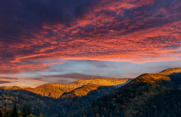 Wonderful Colorful Sunset In the Mountains. Dramatic Sky over the Mountains under the Sunlight. Picturesque Dramatic Scene. Creative Image. Beauty in the World