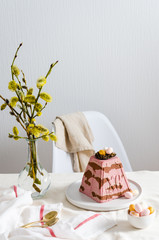 Easter cherry chocolate curd cake with nest and eggs on festive table. Easter card. Copy space