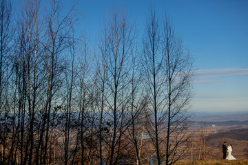 Beautiful wedding couple posing on hills