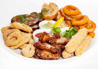 A plate with meat dishes, kebabs, bishtex, sauces and various croutons.