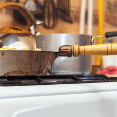 Fototapeta na wymiar Pan on the gas stove close-up. Kitchen utensils. Selective focus