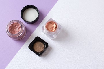 cosmetic top view eye and lip gloss on white background with copy space