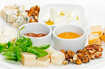 Dish with different types of cheese and sauces. Cheese torte with sauces.