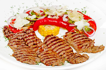 A plate with meat dishes, kebabs, bishtex, sauces and various croutons.