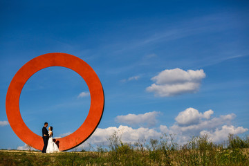 Happy beautiful romantic couple posing on hill